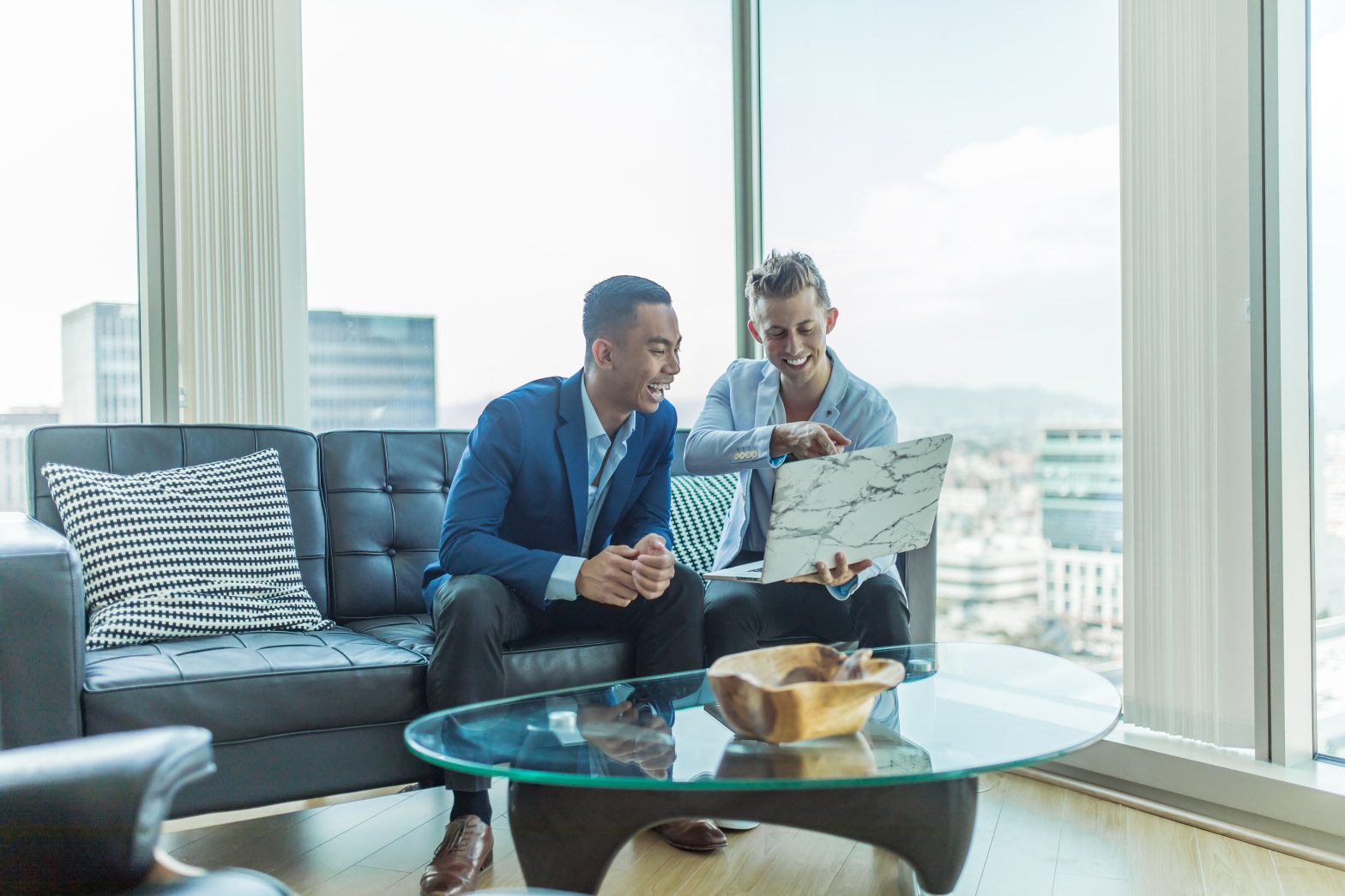 Broker and client looking at a laptop together