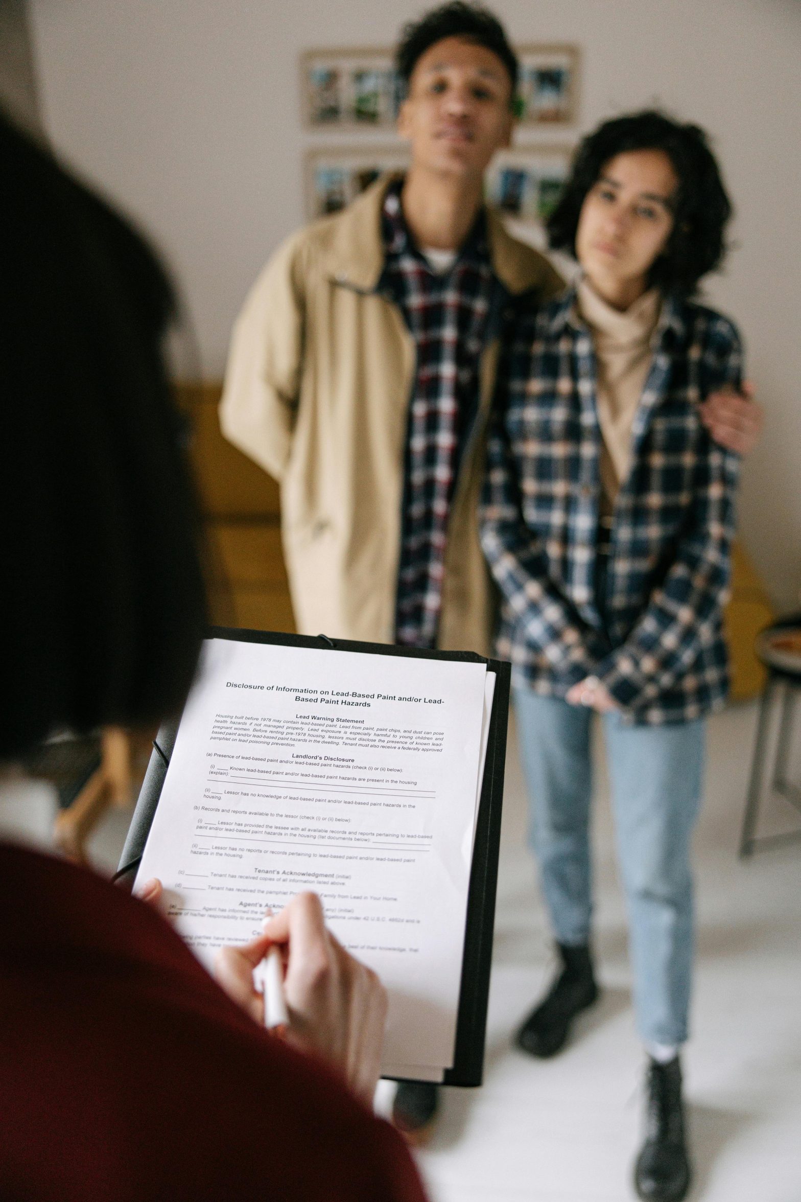 Couple discussing rental agreement with Realtor