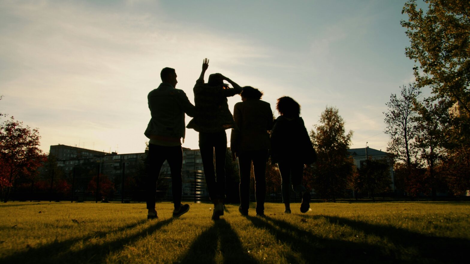A diverse group of friends laughing together outside at a social club meetup in Ottawa.